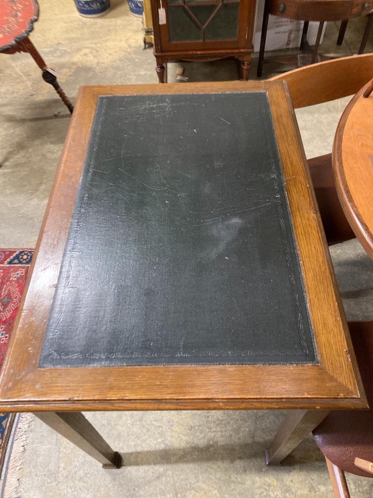 A 1920's oak writing table, width 91cm, depth 60cm, height 76cm